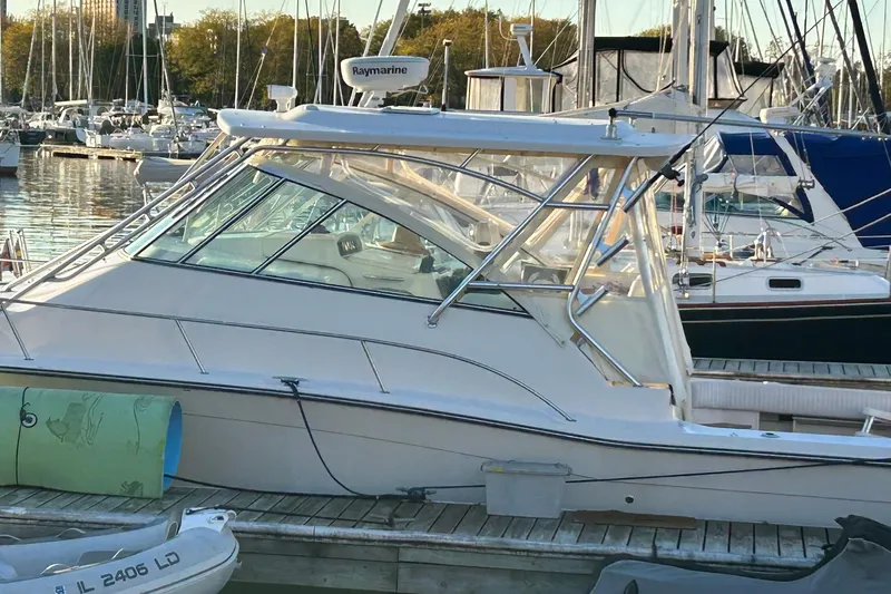 Slide: The Image of 2007 Grady-White Express 360 boat docked in a marina, surrounded by other vessels. - 35