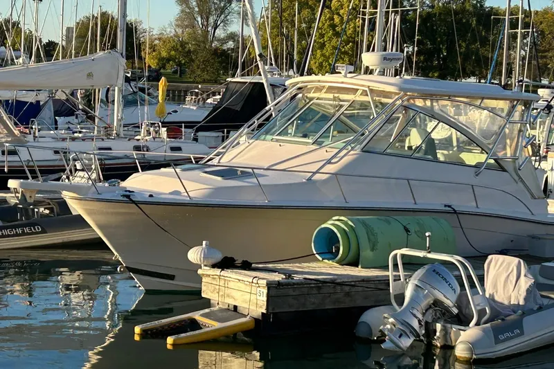 Slide: The Image of 2007 Grady-White Express 360 boat docked in a marina, surrounded by other vessels. - 40
