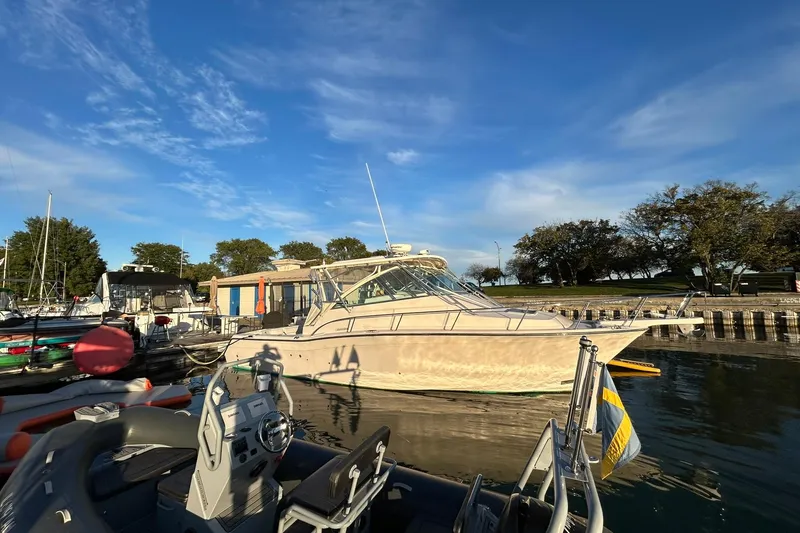 Slide: The Image of 2007 Grady-White Express 360 boat docked at a marina under a clear blue sky. - 43