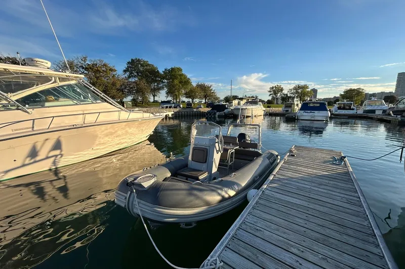 Slide: The Image of 2007 Grady-White Express 360 docked at marina with inflatable boat nearby. - 45