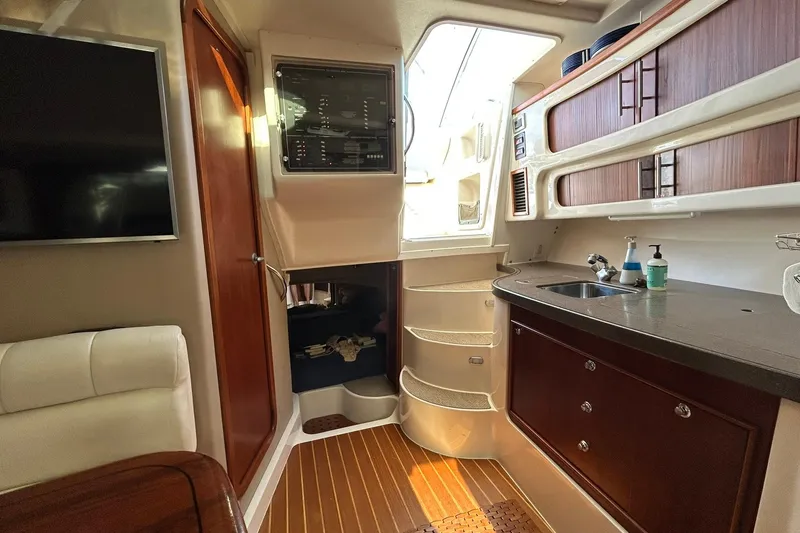 Slide: The Image of Interior of 2007 Grady-White Express 360 boat with kitchenette and seating area. - 48
