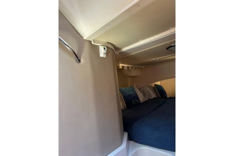 Slide: The Image of 2007 Grady-White Express 360 cabin interior with cozy bedding and ambient lighting. - 5