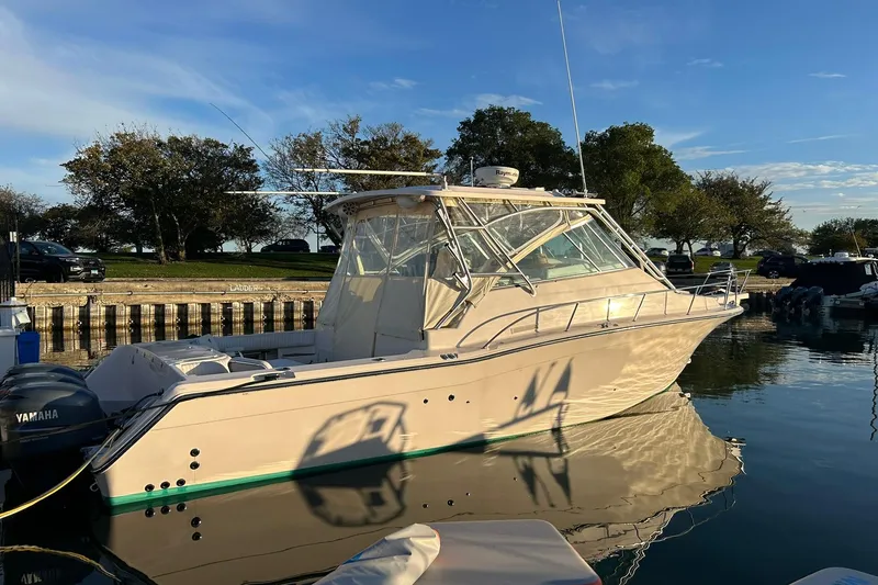Slide: The Image of 2007 Grady-White Express 360 boat docked on calm water, clear sky background. - 51