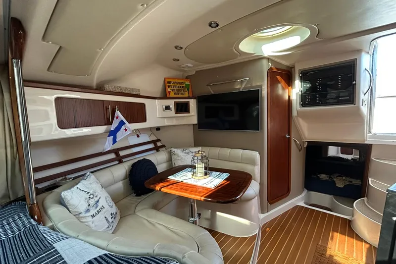 Slide: The Image of Luxurious 2007 Grady-White Express 360 cabin interior with seating, table, and nautical decor. - 53