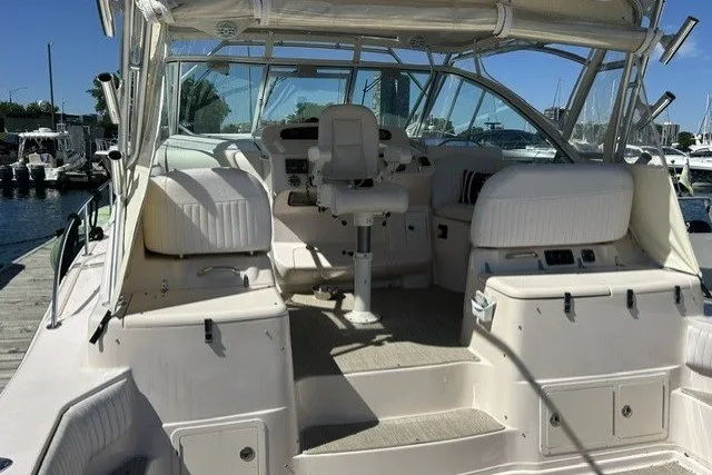 Slide: The Image of 2007 Grady-White Express 360 boat interior at marina, featuring helm and seating area. - 65
