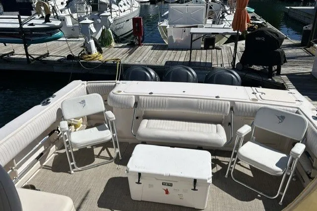 Slide: The Image of 2007 Grady-White Express 360 boat interior with seating and cooler at marina dock. - 72