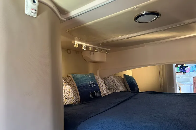 Slide: The Image of 2007 Grady-White Express 360 cabin interior with cozy bedding and ambient lighting. - 8