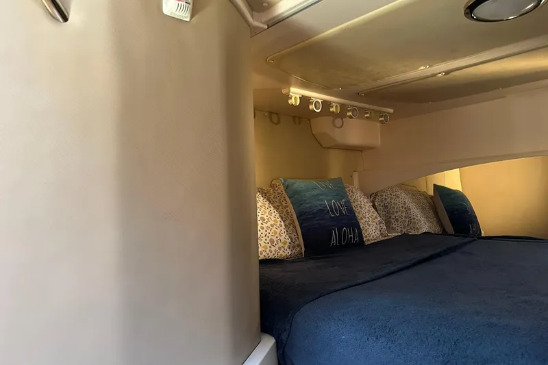 Slide: The Image of Interior cabin of 2007 Grady-White Express 360 with cozy bedding and decorative pillows. - 9