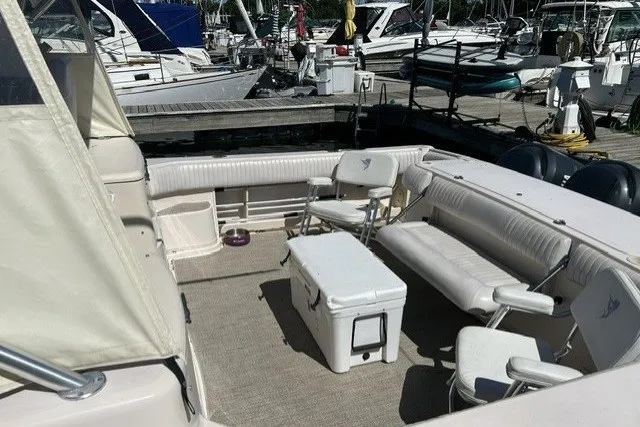 Slide: The Image of 2007 Grady-White Express 360 boat interior with seating and cooler at marina. - 69