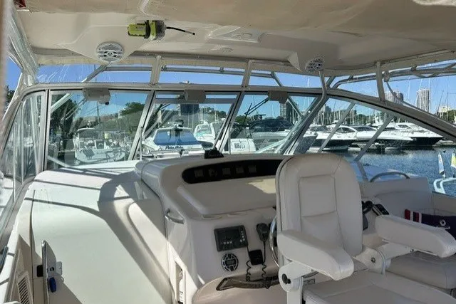 Slide: The Image of 2007 Grady-White Express 360 helm with marina view, showcasing luxury boating features. - 73
