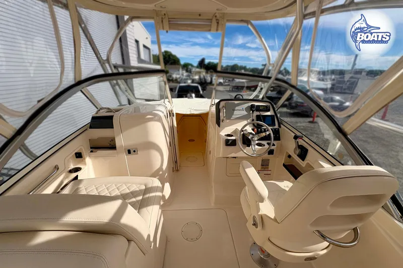 Slide: The Image of 2019 Grady-White Freedom 235 boat interior with helm, seating, and navigation equipment. - 10