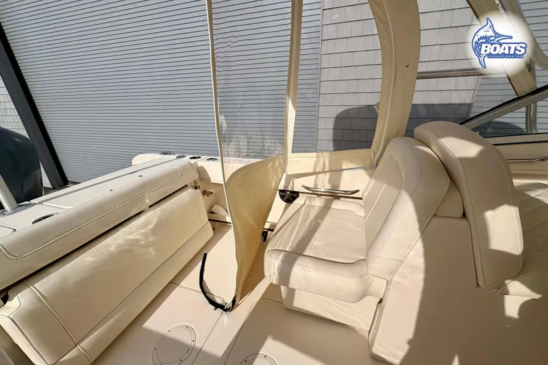 Slide: The Image of 2019 Grady-White Freedom 235 boat interior with beige seating and canopy. - 11