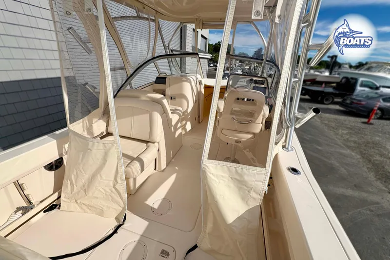 Slide: The Image of 2019 Grady-White Freedom 235 boat interior with seating and helm, showcasing luxury design. - 12