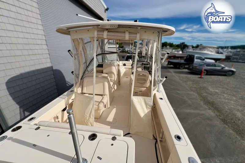 Slide: The Image of 2019 Grady-White Freedom 235 boat with spacious deck and seating, parked outdoors. - 13