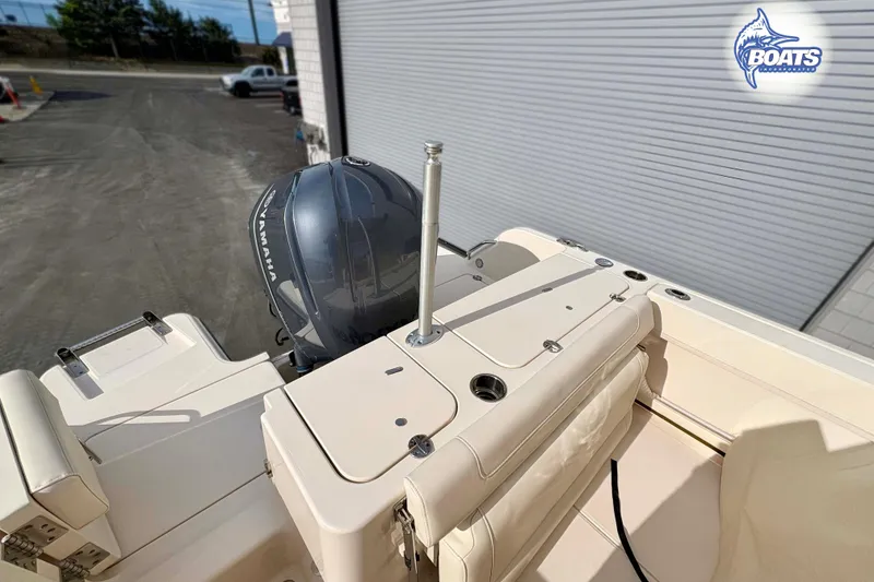 Slide: The Image of 2019 Grady-White Freedom 235 boat with Yamaha engine, docked near a warehouse. - 14