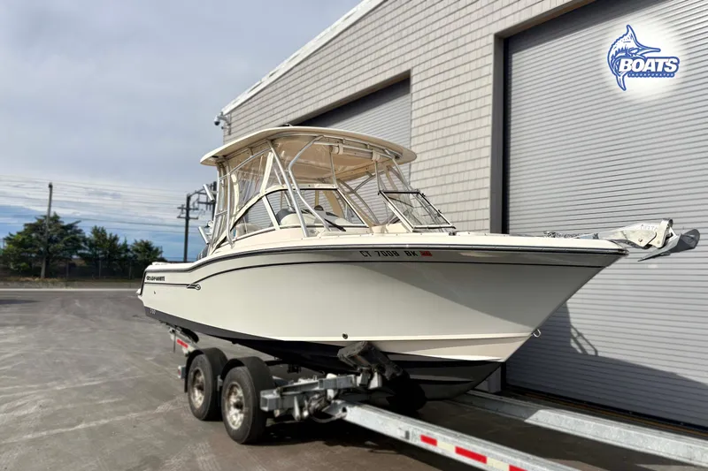 Slide: The Image of 2019 Grady-White Freedom 235 boat on trailer near industrial building. - 2
