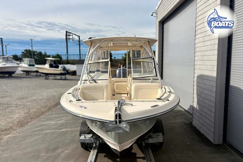 Slide: The Image of 2019 Grady-White Freedom 235 boat on trailer, parked near a building. - 3