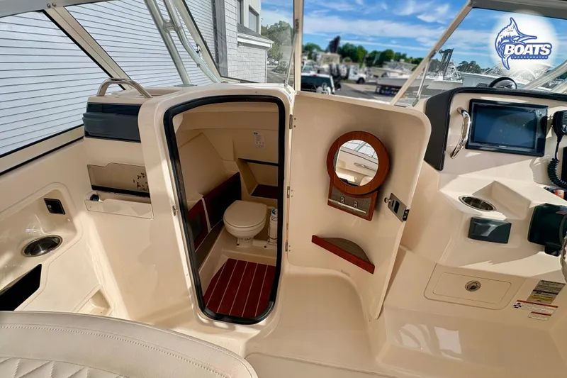 Slide: The Image of 2019 Grady-White Freedom 235 boat interior with cabin and helm station. - 6