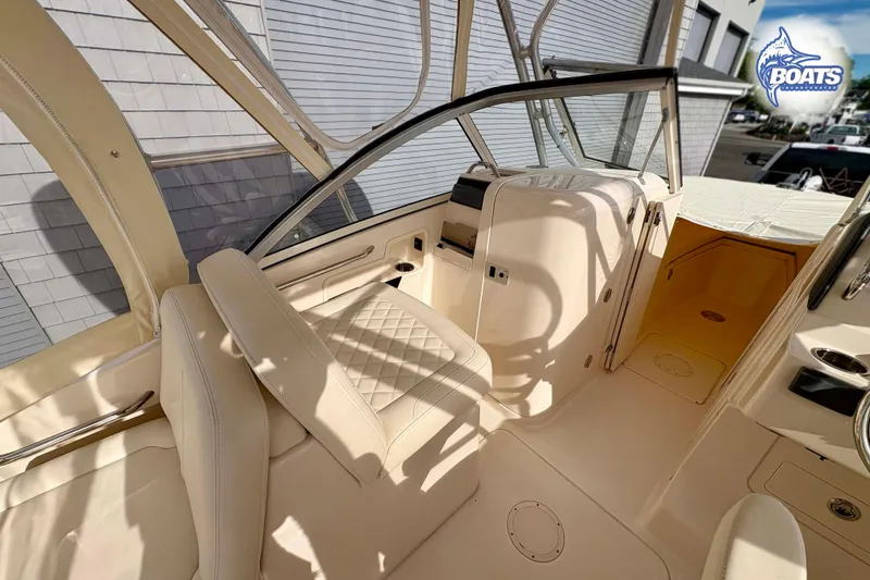 Slide: The Image of 2019 Grady-White Freedom 235 boat interior with beige seating and helm area. - 7