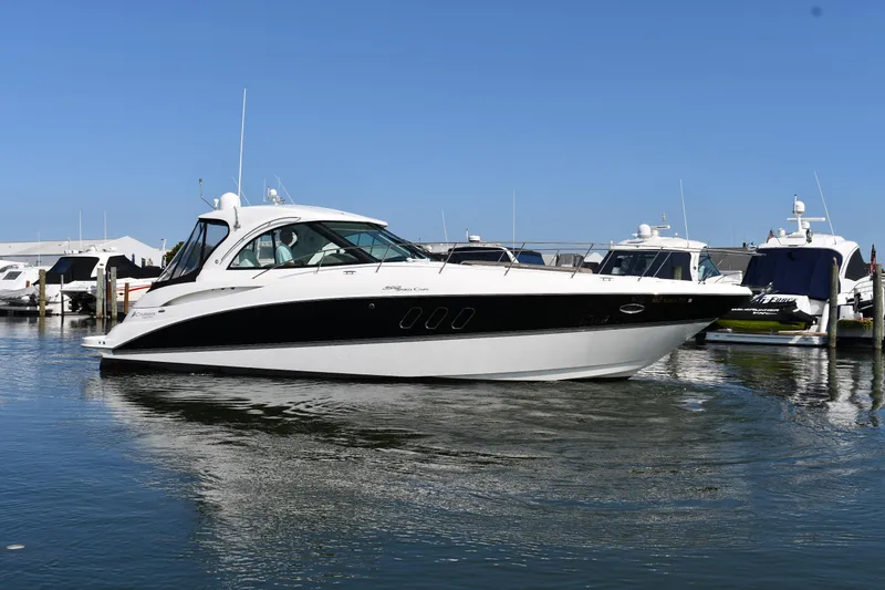 The Image of 2010 Cruisers Yachts 390 Sports Coupe in marina, sleek design, calm water. - 0