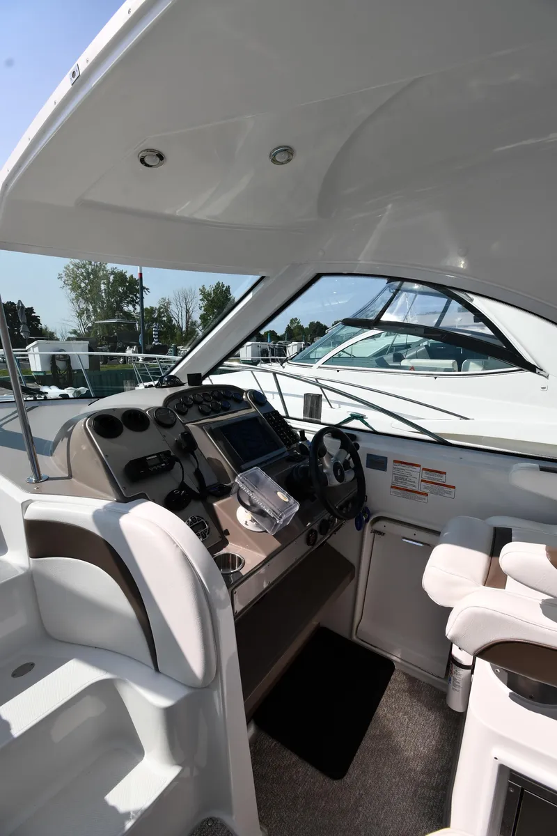 Slide: The Image of 2010 Cruisers Yachts 390 Sports Coupe helm with modern controls and seating. - 13