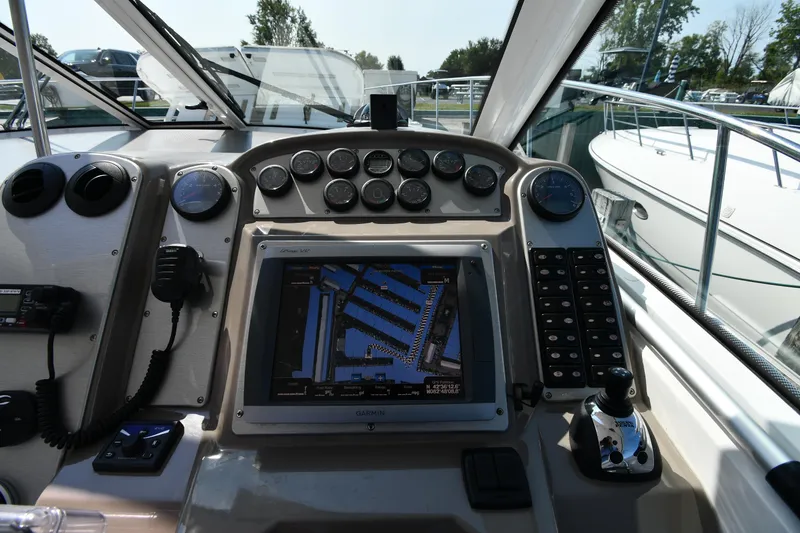 Slide: The Image of Dashboard of 2010 Cruisers Yachts 390 Sports Coupe with navigation system and controls. - 14