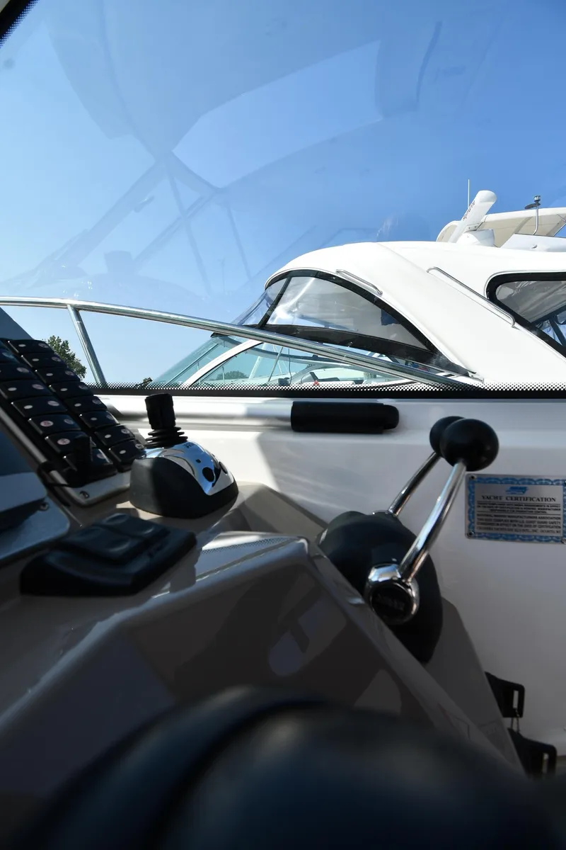 Slide: The Image of 2010 Cruisers Yachts 390 Sports Coupe cockpit with controls and clear blue sky. - 16
