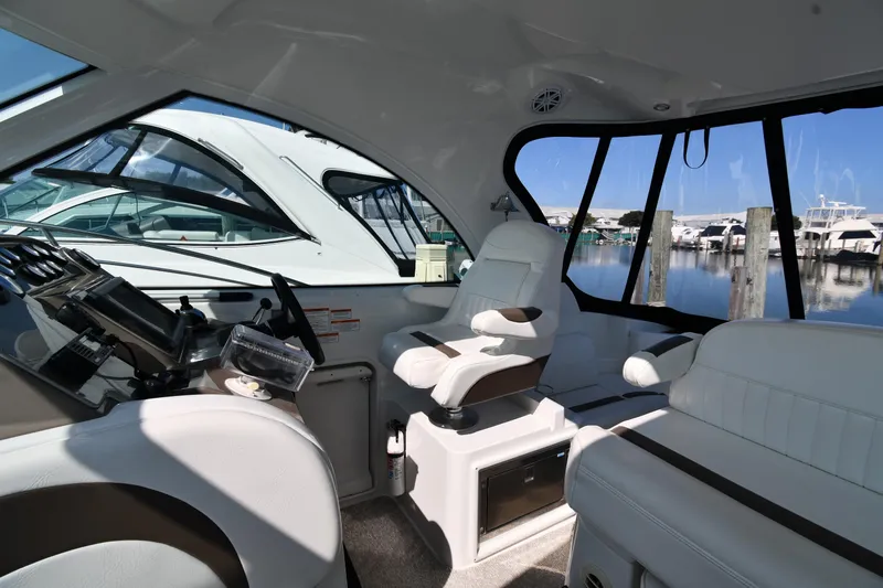 Slide: The Image of Interior of 2010 Cruisers Yachts 390 Sports Coupe, featuring helm and seating area. - 17