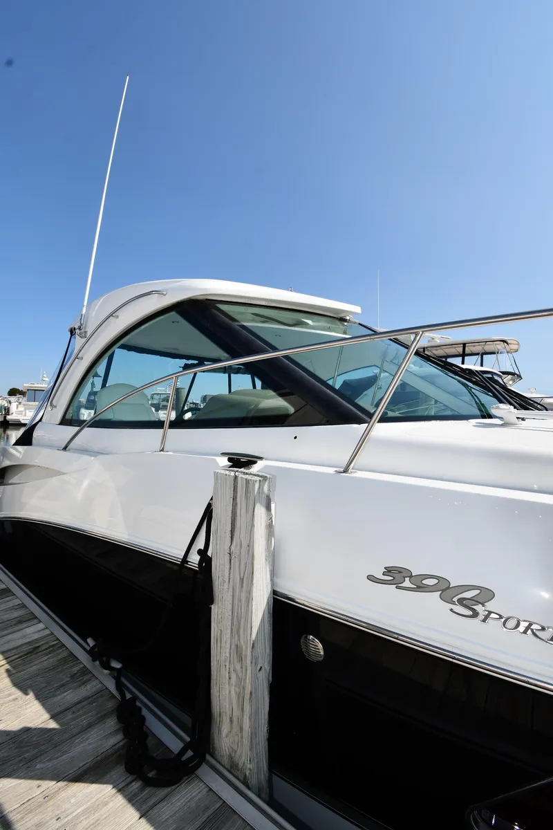 Slide: The Image of 2010 Cruisers Yachts 390 Sports Coupe docked, showcasing sleek design and modern features. - 2