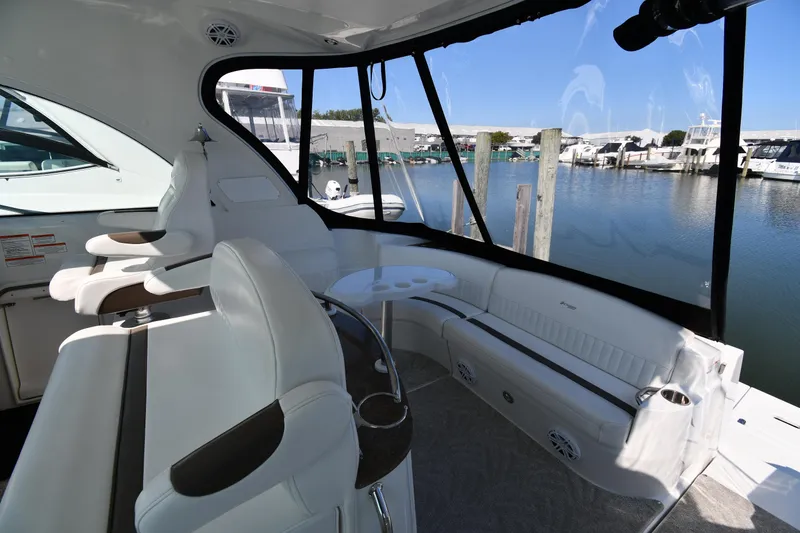 Slide: The Image of 2010 Cruisers Yachts 390 Sports Coupe interior with white seating and marina view. - 25