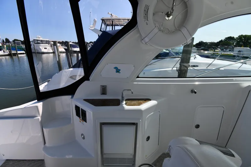 Slide: The Image of 2010 Cruisers Yachts 390 Sports Coupe interior with sink and marina view. - 27