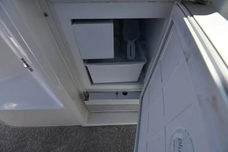 Slide: The Image of Open storage compartment on 2010 Cruisers Yachts 390 Sports Coupe. - 28