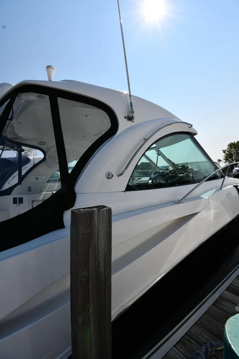 Slide: The Image of 2010 Cruisers Yachts 390 Sports Coupe docked under bright sun. - 3