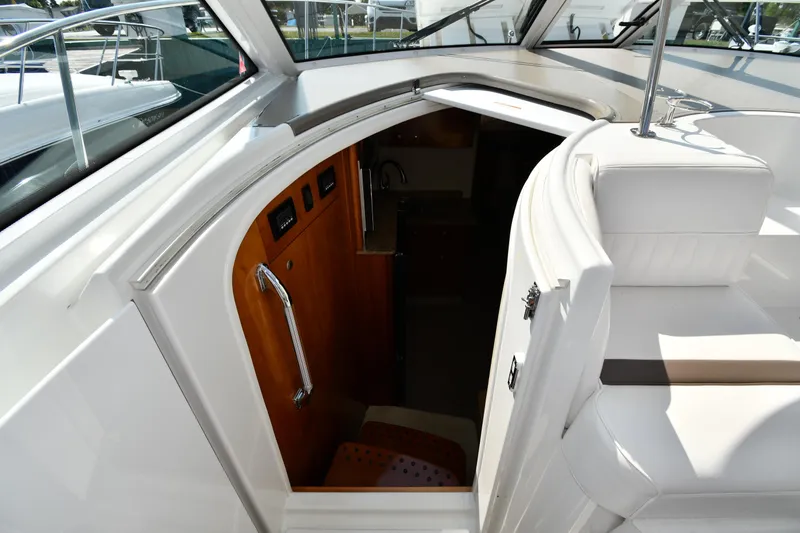 Slide: The Image of 2010 Cruisers Yachts 390 Sports Coupe interior entrance with sleek white seating and wooden accents. - 35