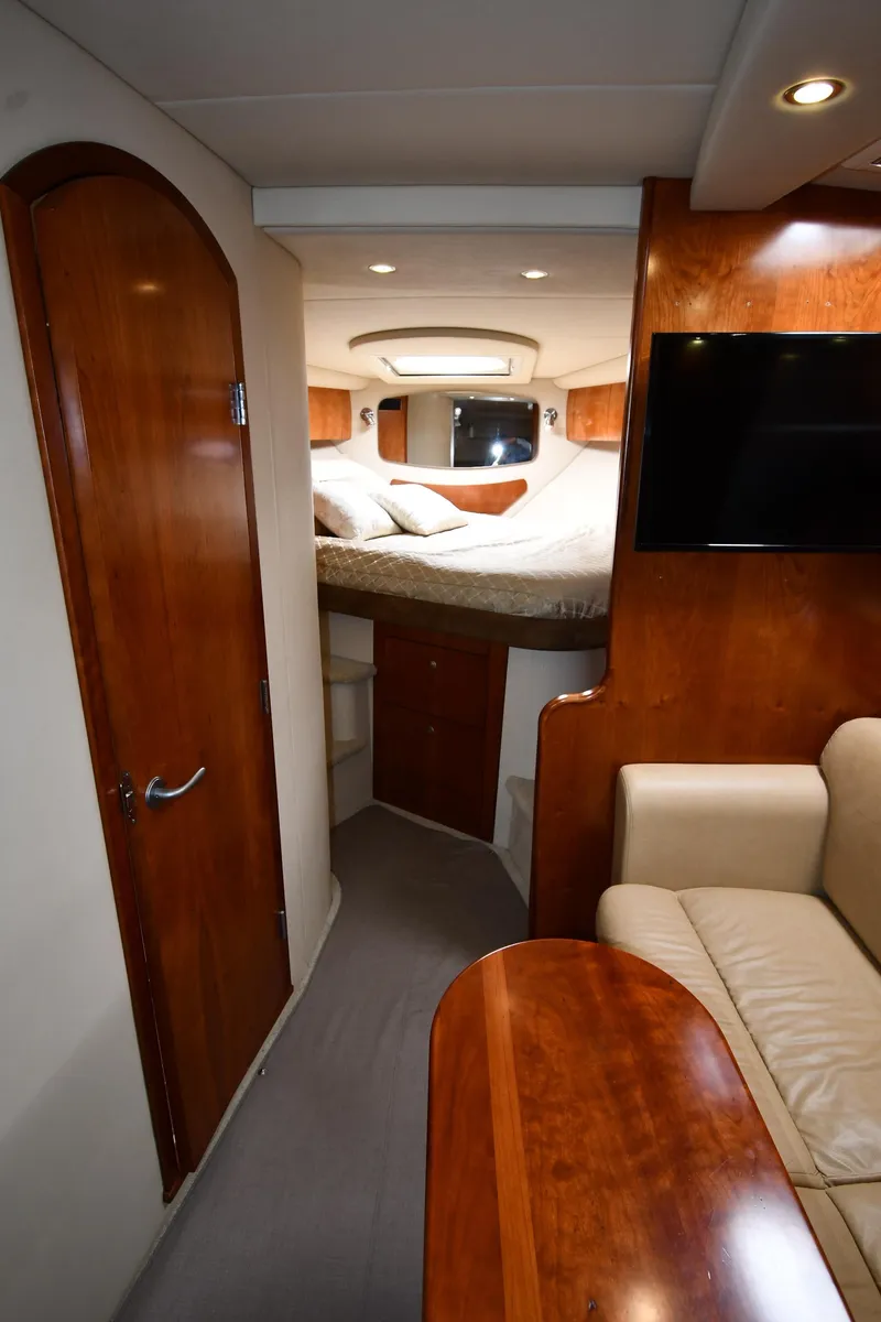 Slide: The Image of Interior of 2010 Cruisers Yachts 390 Sports Coupe, featuring cozy cabin and elegant wood finishes. - 36