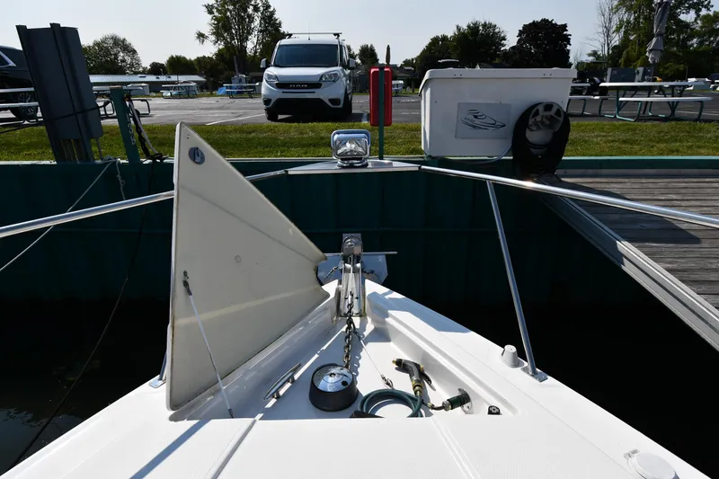 Slide: The Image of 2010 Cruisers Yachts 390 Sports Coupe docked, showing bow details and marina surroundings. - 4