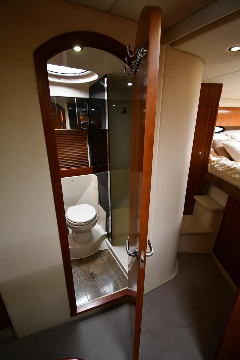 Slide: The Image of 2010 Cruisers Yachts 390 Sports Coupe bathroom interior with wooden door and modern fixtures. - 42