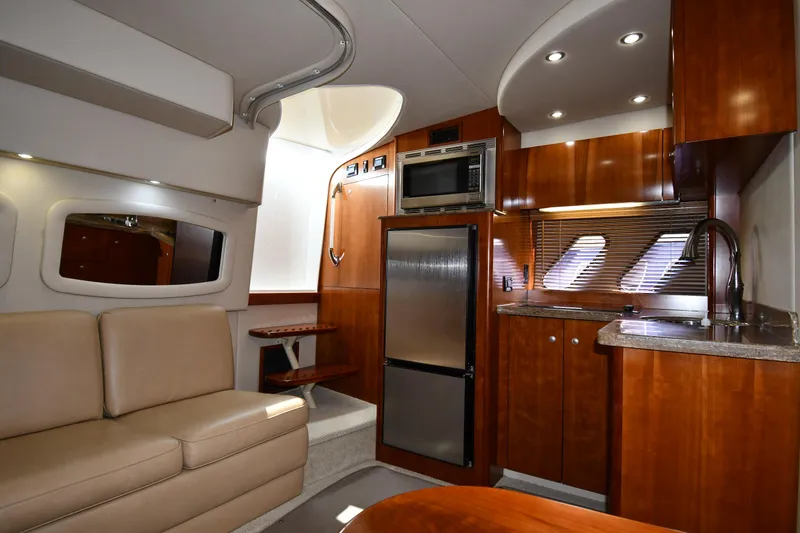 Slide: The Image of Interior of 2010 Cruisers Yachts 390 Sports Coupe with modern kitchen and seating area. - 49