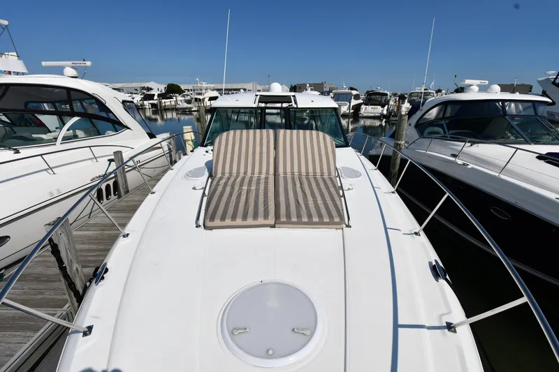 Slide: The Image of 2010 Cruisers Yachts 390 Sports Coupe docked with sun loungers on deck. - 6