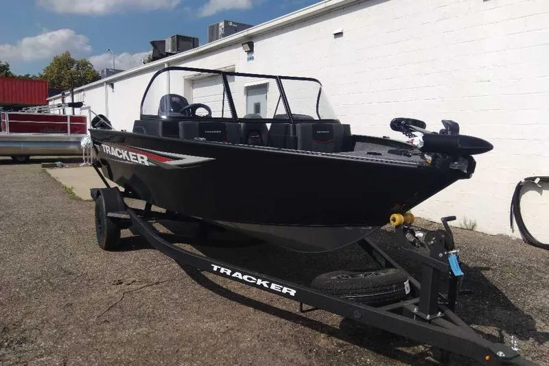 Slide: The Image of 2026 Tracker Pro Guide V-175 Combo boat on trailer, parked outdoors. - 2