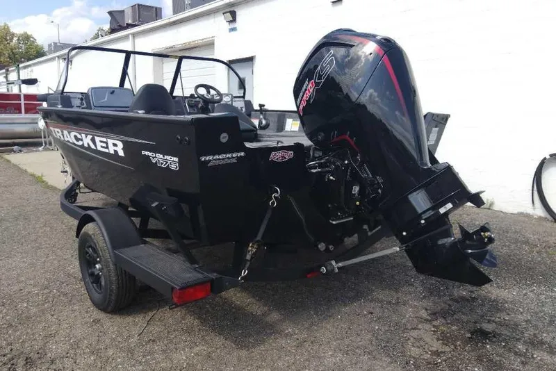 Slide: The Image of 2026 Tracker Pro Guide V-175 Combo boat with powerful outboard motor, parked on trailer. - 5