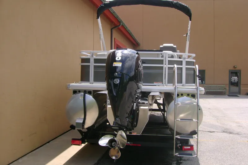Slide: The Image of 2026 Sun Tracker Fishin' Barge 22 XP3 pontoon boat with outboard motor, rear view. - 4