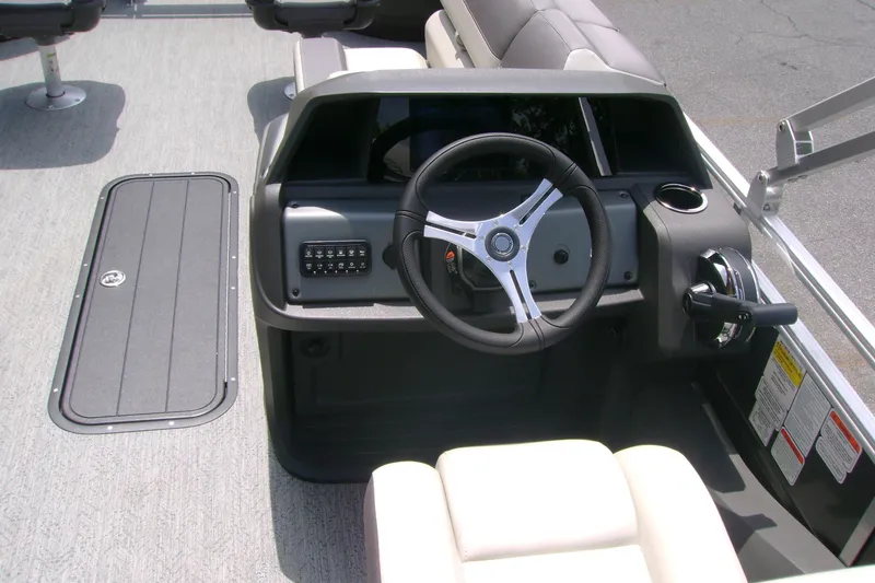 Slide: The Image of 2026 Sun Tracker Fishin' Barge 22 XP3 steering console with modern controls and seating. - 7