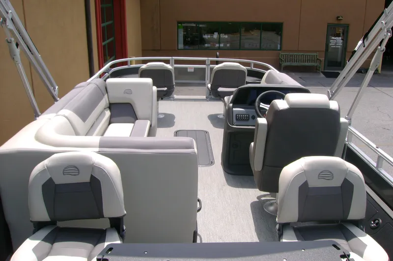 Slide: The Image of 2026 Sun Tracker Fishin' Barge 22 XP3 interior with seating and steering console. - 6