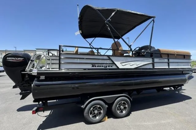 Slide: The Image of 2026 Ranger 220FC pontoon boat with Mercury engine on a trailer, featuring a black canopy. - 3