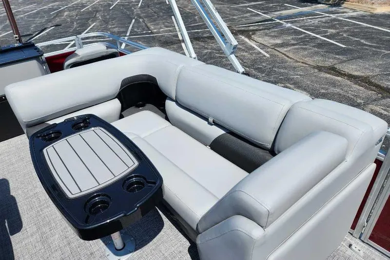 Slide: The Image of 2026 Sun Tracker SportFish 20 DLX boat interior with gray seating and cupholder table. - 10