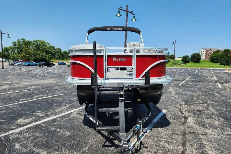 Slide: The Image of 2026 Sun Tracker SportFish 20 DLX pontoon boat on trailer in parking lot. - 3