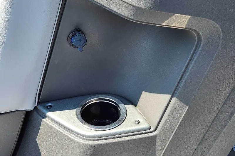 Slide: The Image of 2026 Sun Tracker SportFish 20 DLX boat interior with cup holder and power outlet. - 8