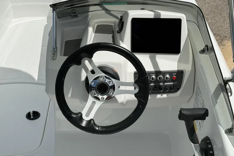 Slide: The Image of 2026 Tahoe T16 boat dashboard with steering wheel and control panel. - 5