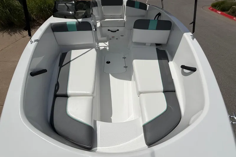 Slide: The Image of 2026 Tahoe T16 boat interior with white and gray seating, docked outdoors. - 3